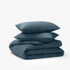 The Tuft and Needle Percale Duvet Cover Set folded and stacked on a white background||color:slate