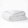 The Tuft and Needle Down Duvet Insert folded on a white background||weight:light